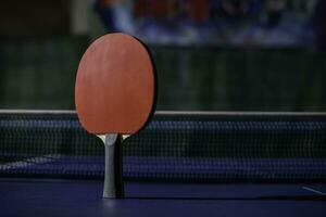 table tennis racket On the blue ping pong table photo