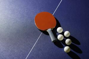 table tennis racket On the blue ping pong table photo