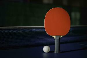 table tennis racket On the blue ping pong table photo