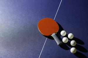 table tennis racket On the blue ping pong table photo