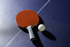 table tennis racket On the blue ping pong table photo