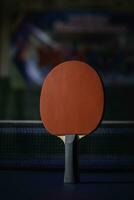 table tennis racket On the blue ping pong table photo