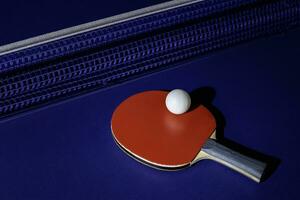 table tennis racket On the blue ping pong table photo