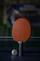 table tennis racket On the blue ping pong table photo