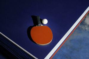 table tennis racket On the blue ping pong table photo