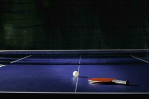 table tennis racket On the blue ping pong table photo