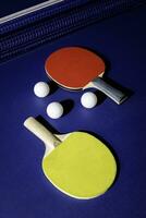 table tennis racket On the blue ping pong table photo