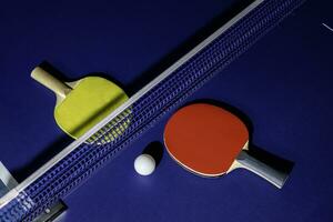 table tennis racket On the blue ping pong table photo