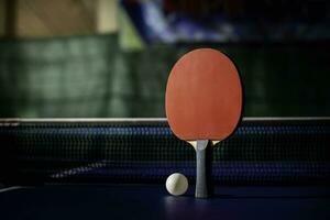 table tennis racket On the blue ping pong table photo