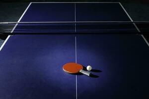 table tennis racket On the blue ping pong table photo