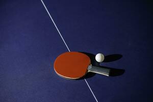 table tennis racket On the blue ping pong table photo