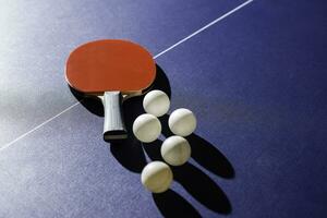 table tennis racket On the blue ping pong table photo