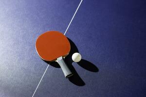 table tennis racket On the blue ping pong table photo