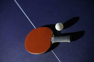 table tennis racket On the blue ping pong table photo