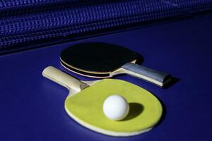 table tennis racket On the blue ping pong table photo