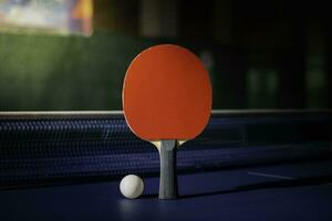 table tennis racket On the blue ping pong table photo