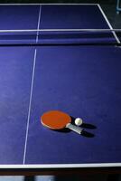 table tennis racket On the blue ping pong table photo