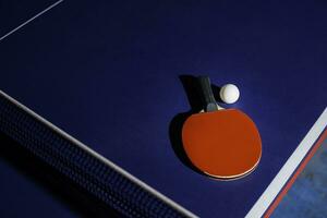 table tennis racket On the blue ping pong table photo