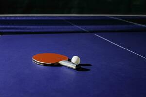 table tennis racket On the blue ping pong table photo