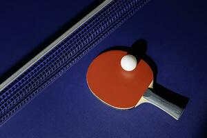 table tennis racket On the blue ping pong table photo