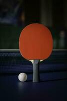 table tennis racket On the blue ping pong table photo