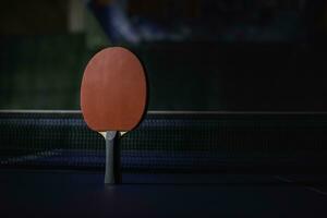 table tennis racket On the blue ping pong table photo