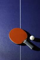 table tennis racket On the blue ping pong table photo