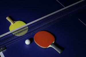 table tennis racket On the blue ping pong table photo