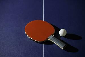 table tennis racket On the blue ping pong table photo