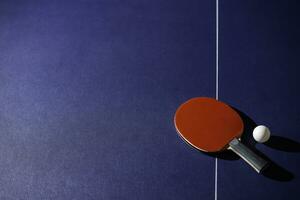 table tennis racket On the blue ping pong table photo