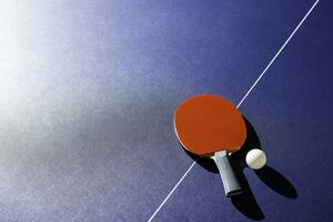 table tennis racket On the blue ping pong table photo