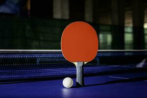 table tennis racket On the blue ping pong table photo