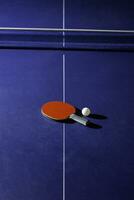 table tennis racket On the blue ping pong table photo