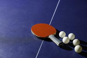 table tennis racket On the blue ping pong table photo