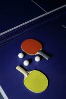 table tennis racket On the blue ping pong table photo