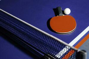 table tennis racket On the blue ping pong table photo