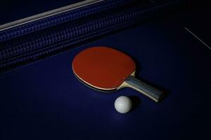 table tennis racket On the blue ping pong table photo