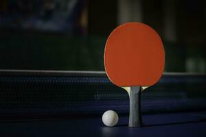 table tennis racket On the blue ping pong table photo