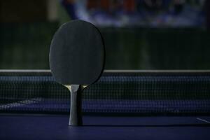 table tennis racket On the blue ping pong table photo