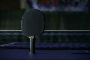 table tennis racket On the blue ping pong table photo