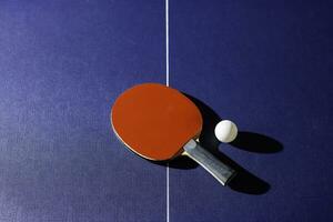 table tennis racket On the blue ping pong table photo