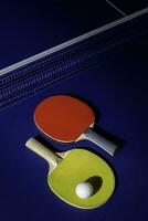 table tennis racket On the blue ping pong table photo