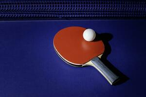 table tennis racket On the blue ping pong table photo