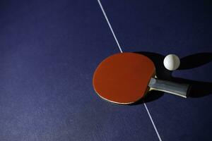 table tennis racket On the blue ping pong table photo