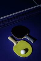 table tennis racket On the blue ping pong table photo