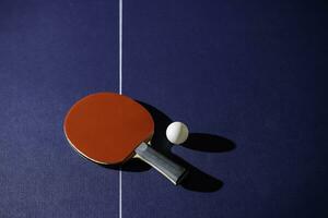 table tennis racket On the blue ping pong table photo