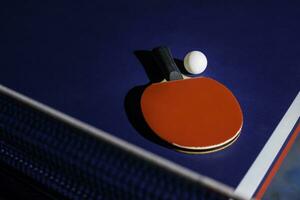 table tennis racket On the blue ping pong table photo