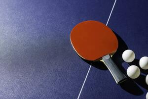 table tennis racket On the blue ping pong table photo