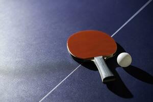 table tennis racket On the blue ping pong table photo