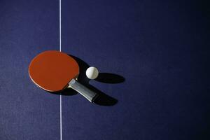 table tennis racket On the blue ping pong table photo